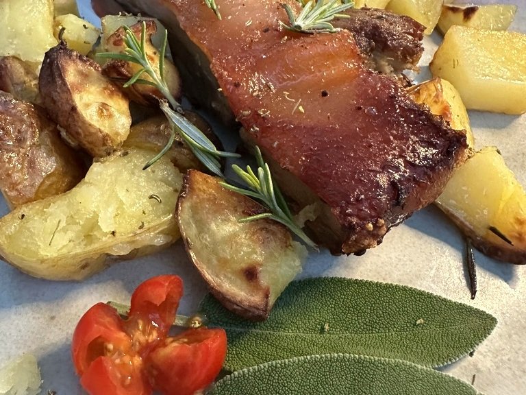 Traditional Tuscan roast with potatoes and herbs served near Sorano